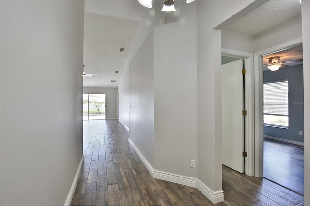 hallway with wood-type flooring and baseboards