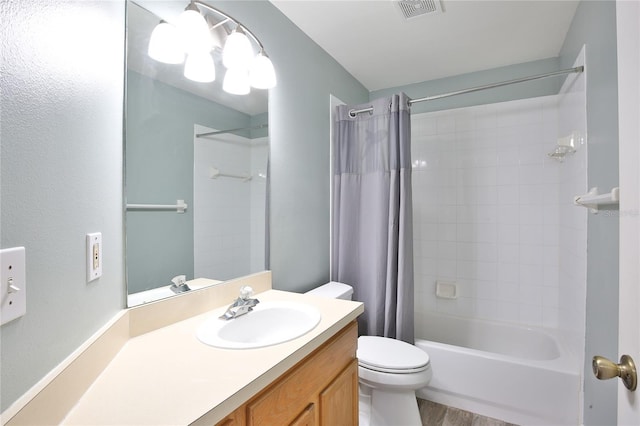 bathroom with toilet, shower / tub combo, visible vents, and vanity