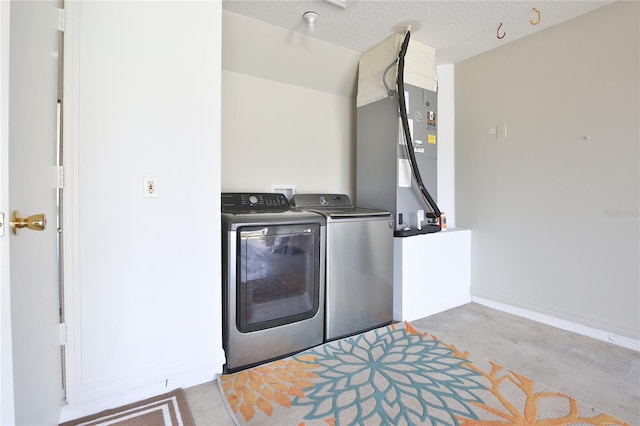 laundry room featuring laundry area, washer and clothes dryer, and a textured ceiling