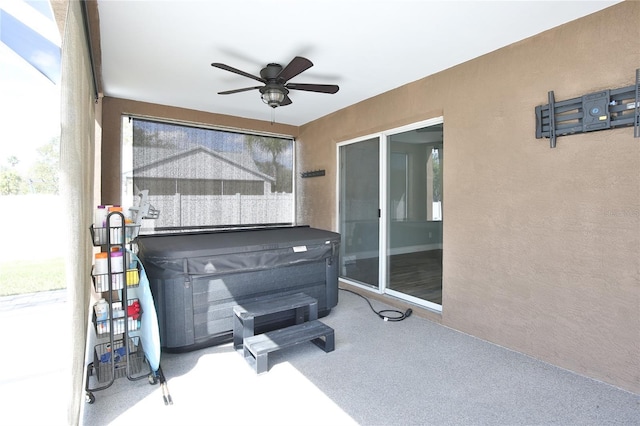 view of patio featuring ceiling fan and a hot tub