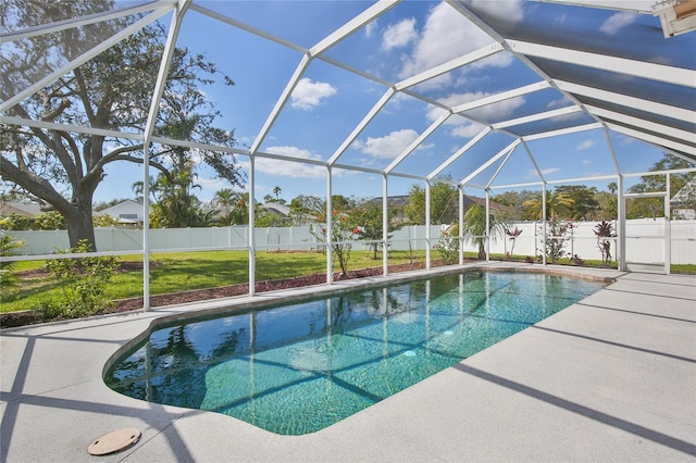 view of swimming pool with a fenced in pool, glass enclosure, a fenced backyard, and a lawn