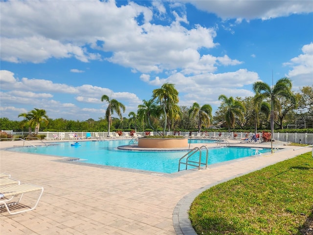 community pool featuring a patio area and fence