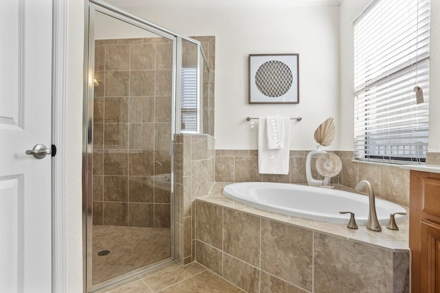 full bath with tile patterned flooring, a garden tub, and a shower stall