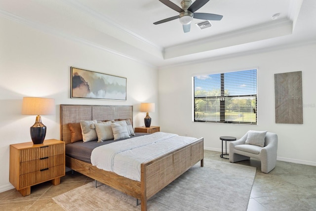 bedroom featuring baseboards, visible vents, a raised ceiling, and crown molding