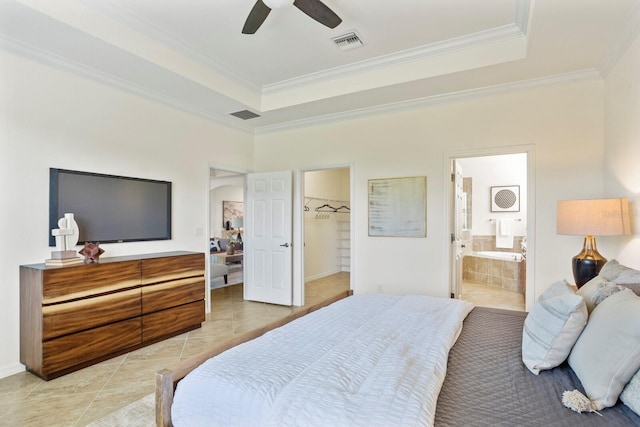 bedroom with light tile patterned floors, visible vents, a tray ceiling, and ornamental molding