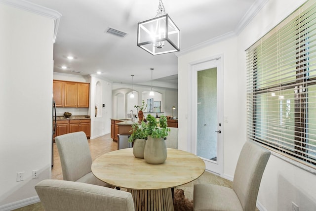 dining room featuring visible vents, arched walkways, crown molding, a notable chandelier, and recessed lighting