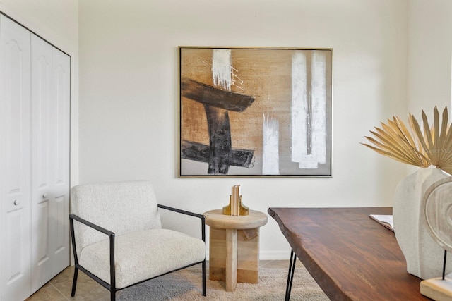 sitting room with tile patterned flooring and baseboards