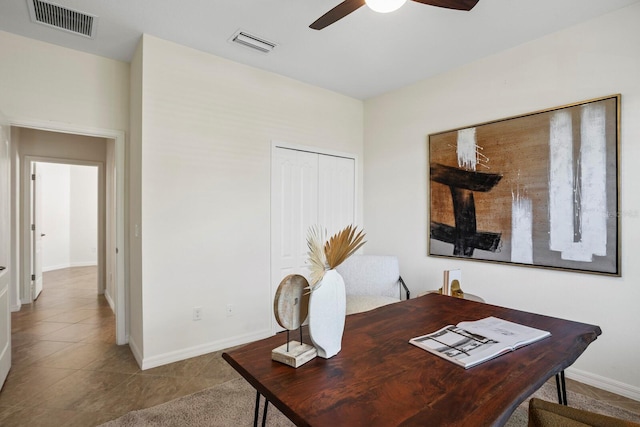 office space with visible vents, ceiling fan, baseboards, and tile patterned floors