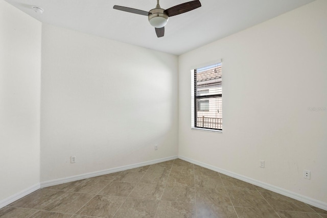 unfurnished room with a ceiling fan and baseboards