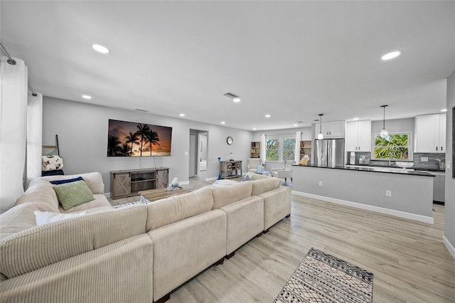 691 Gulf Bay Rd, Longboat Key, FL 34228 - living room with recessed lighting, light wood-type flooring, and baseboards