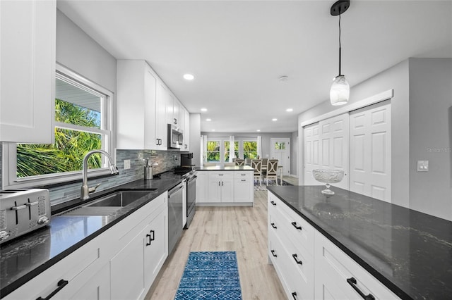 691 Gulf Bay Rd, Longboat Key, FL 34228 - kitchen featuring a sink, stainless steel appliances, recessed lighting, light wood-style flooring, and tasteful backsplash