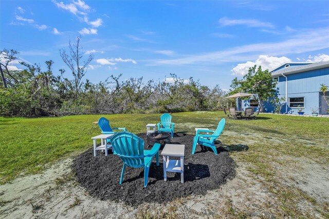 691 Gulf Bay Rd, Longboat Key, FL 34228 - view of grassy yard with an outdoor fire pit