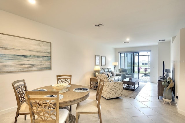 dining area with baseboards, visible vents, and light tile patterned flooring