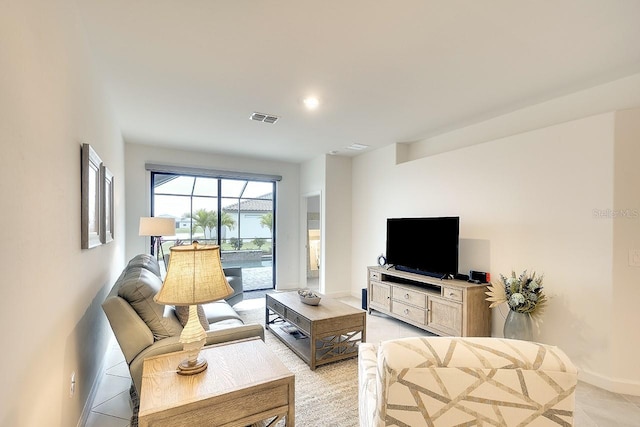 living area with visible vents and baseboards