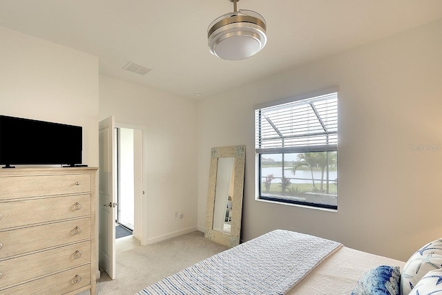 bedroom with baseboards, visible vents, and light colored carpet