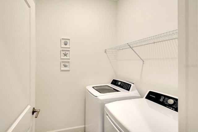 washroom featuring laundry area and separate washer and dryer