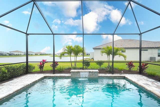 pool featuring a yard, glass enclosure, central AC unit, and a patio