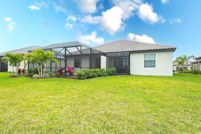 back of property featuring a lanai, stucco siding, a lawn, and a tiled roof