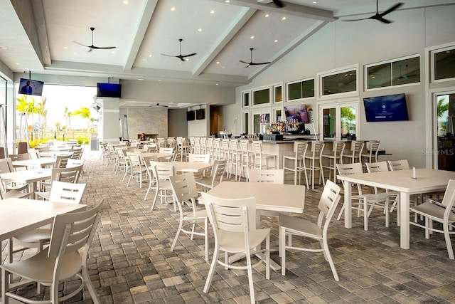 dining area with high vaulted ceiling, recessed lighting, beamed ceiling, and a ceiling fan