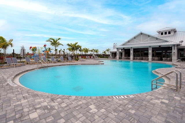 community pool featuring a patio area and fence