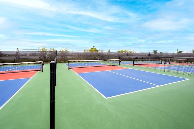 view of sport court featuring fence