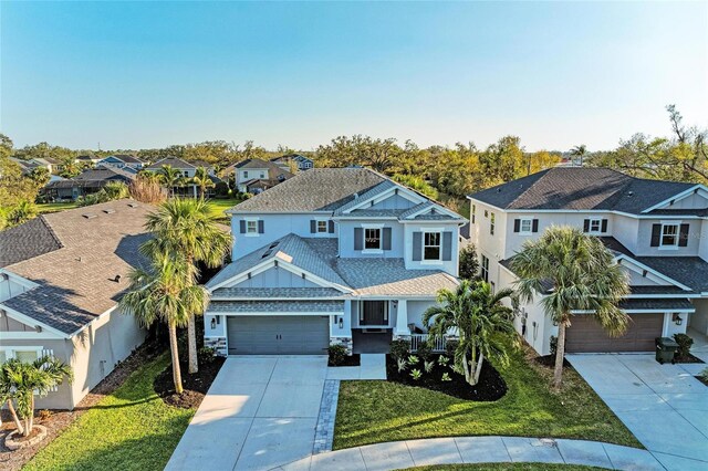 5709 Sunflower Cir, Sarasota, FL 34238 - view of front of house with a garage, a residential view, concrete driveway, and a front yard