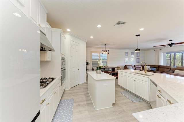 5709 Sunflower Cir, Sarasota, FL 34238 - kitchen featuring a center island, visible vents, a sink, white fridge, and under cabinet range hood