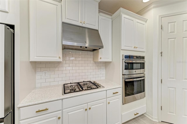 5709 Sunflower Cir, Sarasota, FL 34238 - kitchen featuring tasteful backsplash, light countertops, appliances with stainless steel finishes, white cabinets, and under cabinet range hood