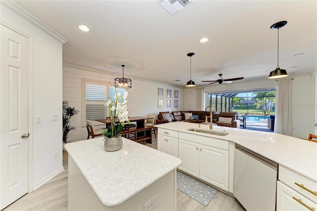 5709 Sunflower Cir, Sarasota, FL 34238 - kitchen featuring ornamental molding, dishwashing machine, light wood finished floors, and a sink