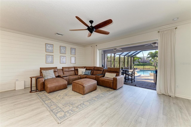 5709 Sunflower Cir, Sarasota, FL 34238 - living room featuring ornamental molding, a sunroom, visible vents, and wood finished floors