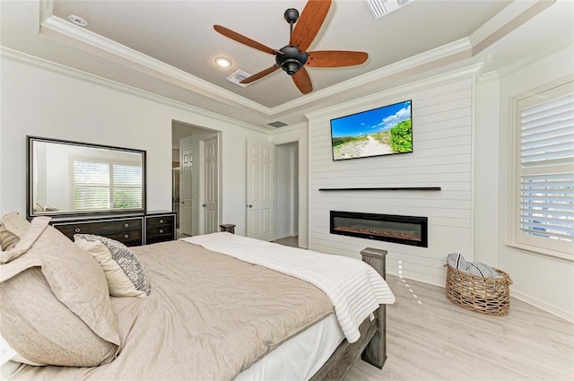 5709 Sunflower Cir, Sarasota, FL 34238 - bedroom featuring visible vents, multiple windows, ornamental molding, and a fireplace