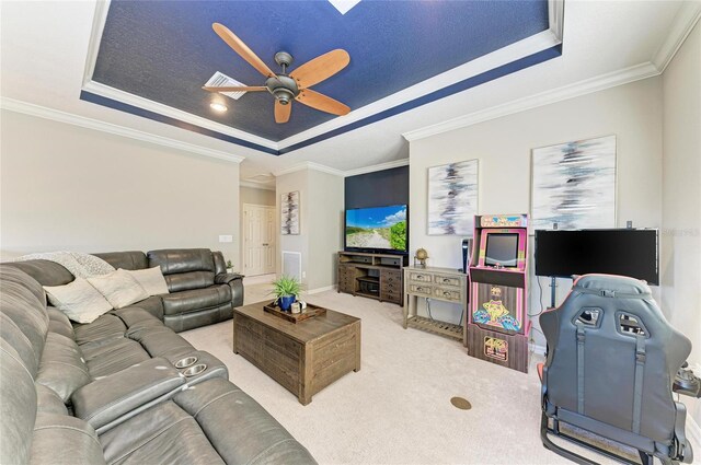 5709 Sunflower Cir, Sarasota, FL 34238 - carpeted living area with ceiling fan, a tray ceiling, baseboards, and crown molding