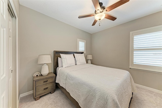 5709 Sunflower Cir, Sarasota, FL 34238 - bedroom featuring a ceiling fan, a closet, light carpet, and baseboards