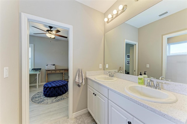 5709 Sunflower Cir, Sarasota, FL 34238 - bathroom with double vanity, baseboards, visible vents, and a sink