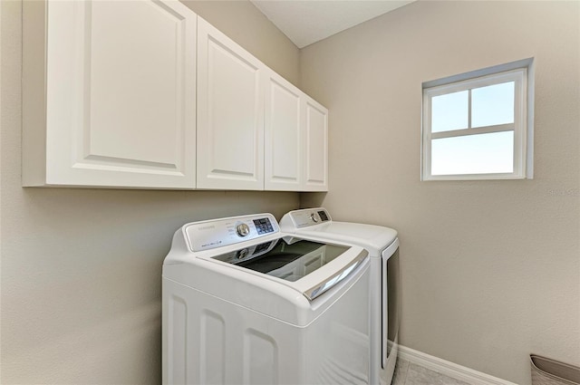 5709 Sunflower Cir, Sarasota, FL 34238 - laundry room featuring cabinet space, baseboards, and separate washer and dryer