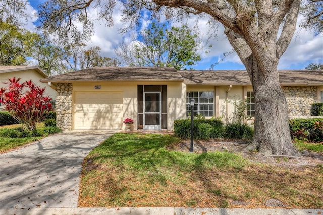 single story home with driveway, stone siding, a garage, and stucco siding