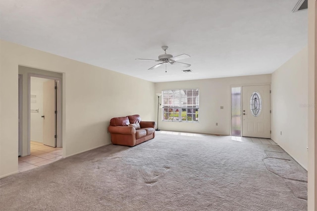 unfurnished room featuring light carpet, visible vents, and a ceiling fan