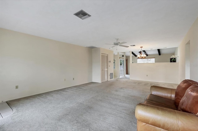 unfurnished living room featuring ceiling fan with notable chandelier, visible vents, and light colored carpet