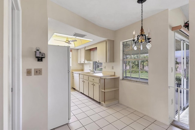 kitchen with light countertops, dishwasher, a sink, and light tile patterned flooring