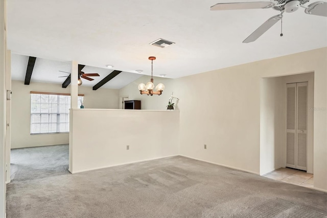 empty room featuring carpet floors, visible vents, vaulted ceiling with beams, and ceiling fan with notable chandelier