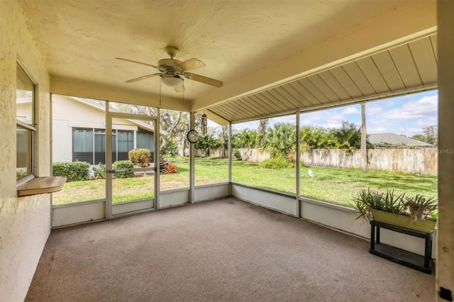 unfurnished sunroom with ceiling fan and a wealth of natural light