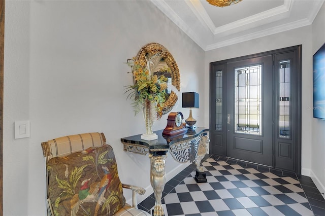 foyer with baseboards, a tray ceiling, crown molding, and tile patterned floors