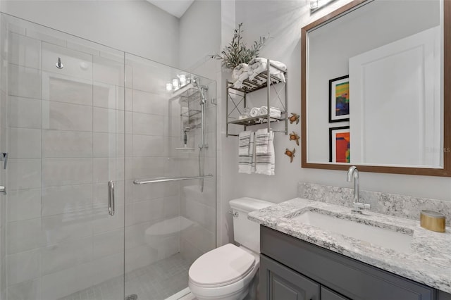 full bath featuring toilet, a shower stall, and vanity