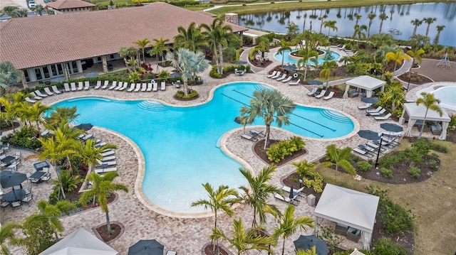 pool with a water view and a patio