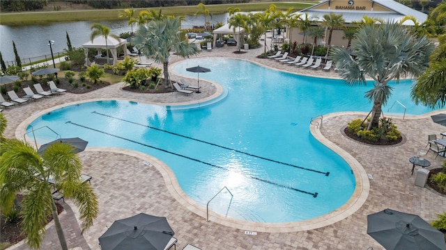 community pool with a water view, a patio area, and a gazebo