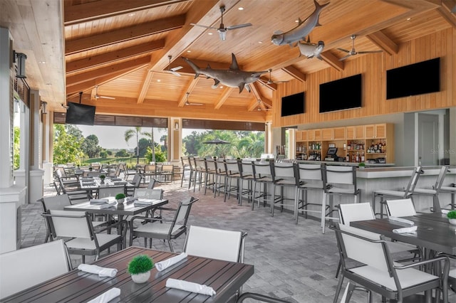 view of patio featuring ceiling fan, a gazebo, outdoor dining space, and outdoor dry bar