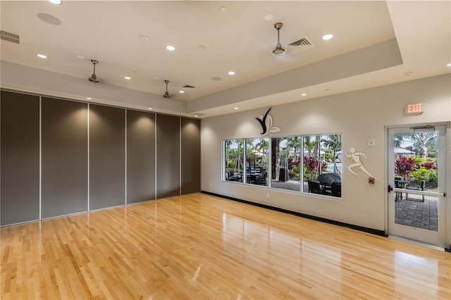 empty room featuring light wood-style floors, visible vents, and recessed lighting