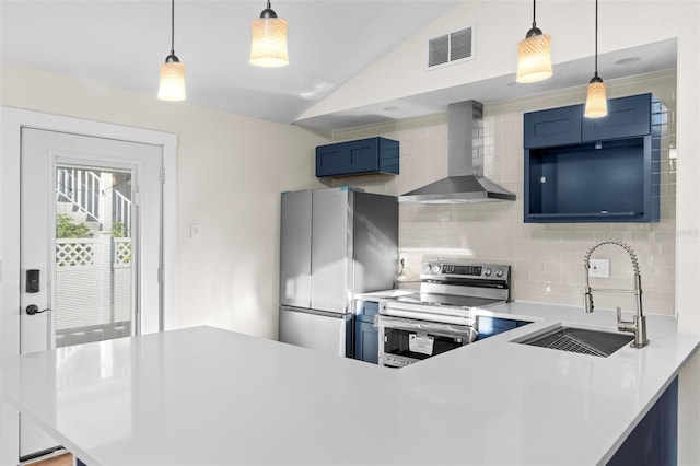 kitchen featuring blue cabinets, a sink, visible vents, wall chimney range hood, and appliances with stainless steel finishes