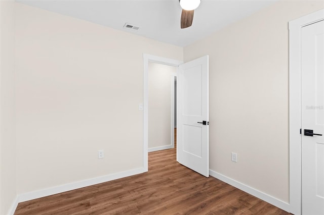 unfurnished bedroom with baseboards, visible vents, and wood finished floors