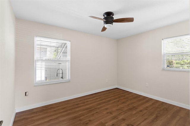 empty room featuring ceiling fan, baseboards, and wood finished floors